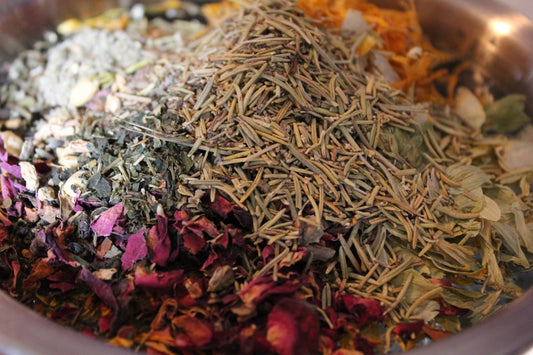 A bowl of herbs rose, lavender, rosemary, hopes, peppermint, etc.,  